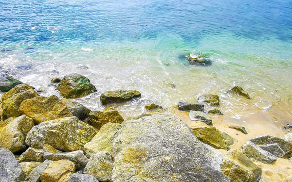 Kalim Sahili tropikal kayalık manzara manzarası turkuaz mavisi berrak su dalgaları ile Patong Sahili Kathu Bölgesi Phuket Adası Güney Tayland 'da kum ve kayalar.