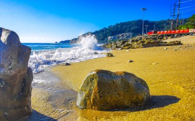 Kalim Sahili tropikal kayalık manzara manzarası turkuaz mavisi berrak su dalgaları ile Patong Sahili Kathu Bölgesi Phuket Adası Güney Tayland 'da kum ve kayalar.