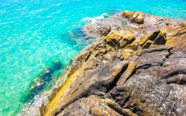 Kalim Sahili kayalık tropikal sahil kıyısı turkuvaz mavisi berrak su dalgaları kum kayaları ve kayalar Patong Sahili Kathu Bölgesi Phuket Adası Güney Tayland Bölgesi.