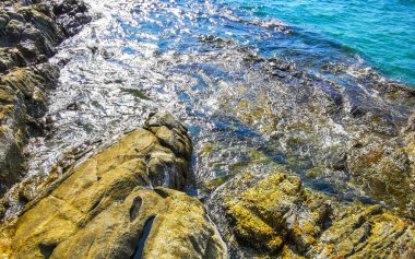 Kalim Sahili kayalık tropikal sahil kıyısı turkuvaz mavisi berrak su dalgaları kum kayaları ve kayalar Patong Sahili Kathu Bölgesi Phuket Adası Güney Tayland Bölgesi.