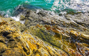 Kalim Sahili kayalık tropikal sahil kıyısı turkuvaz mavisi berrak su dalgaları kum kayaları ve kayalar Patong Sahili Kathu Bölgesi Phuket Adası Güney Tayland Bölgesi.