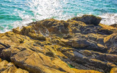 Kalim Sahili kayalık tropikal sahil kıyısı turkuvaz mavisi berrak su dalgaları kum kayaları ve kayalar Patong Sahili Kathu Bölgesi Phuket Adası Güney Tayland Bölgesi.