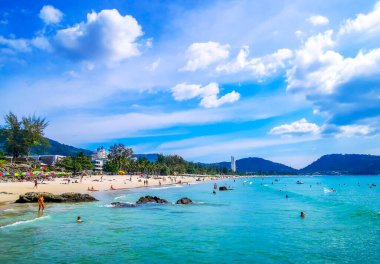 Kathu Bölgesi Phuket Adası, Tayland 14. Şubat 2026 Patong Kamala Sahili Turistlerle su dalgaları güneş şemsiyeleri tropik bitkiler ve palmiye ağaçları Phuket Tayland 'da.