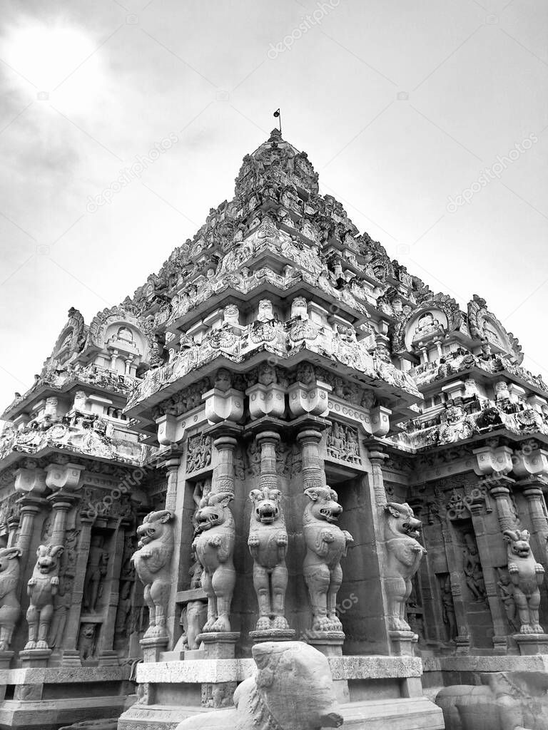 Temple tower against blue sky background. Ancient Hindu temple with sandstone carved historical Hindu God and animal sculptures.