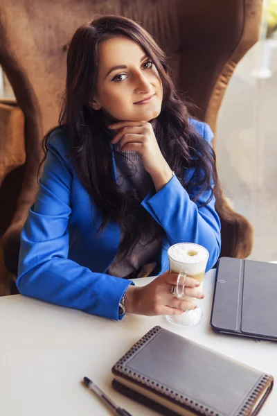 Brunette woman in business clothes: grey sweater and blue jacket — Stock Photo, Image