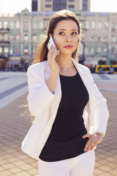 Beautiful brunette business woman in white suit and black t-shir — Stock Photo, Image
