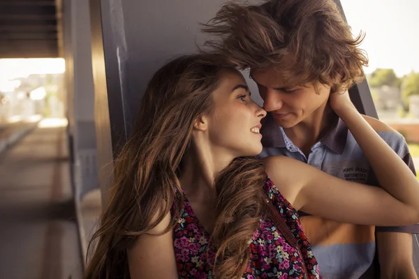橋塔に夏の夏時間で抱き締める若いカップル — ストック写真