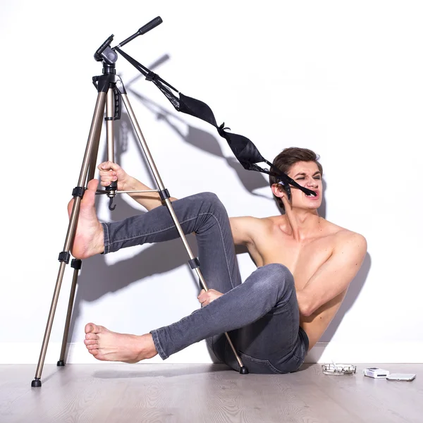 Brunette man do crazy fun in jeans and underwear on a floor. ind — Stock Photo, Image