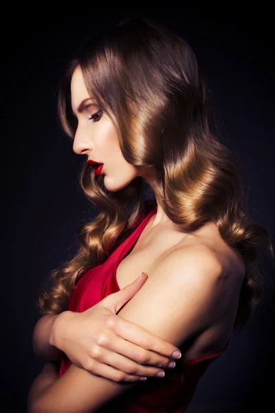 Brunette beautiful luxury woman in red dress with clear skin and — Stock Photo, Image