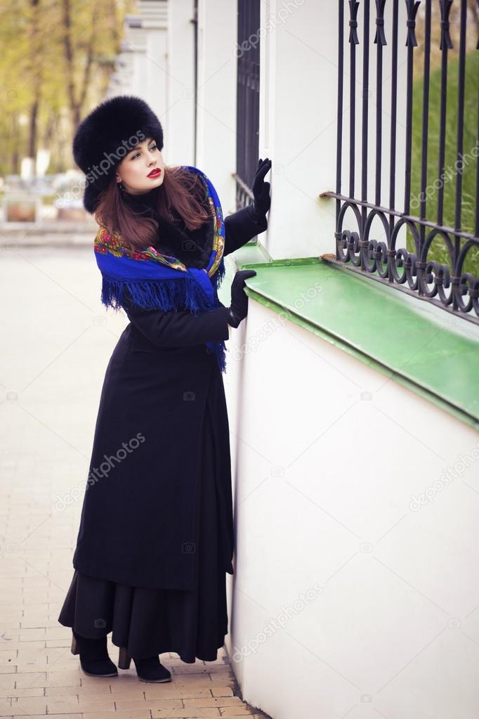 Beautiful brunette russian noblewoman outdoors on autumn day. re