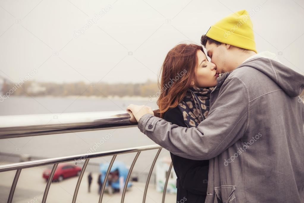 Cute brunette loving couple on a date. cold autumn, winter or sp