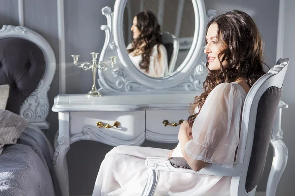 Schwangere sexy kaukasische weiße Frau mit lockiger Frisur sitzt — Stockfoto