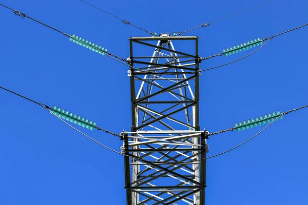 Electric power transmission close-up against blue sky