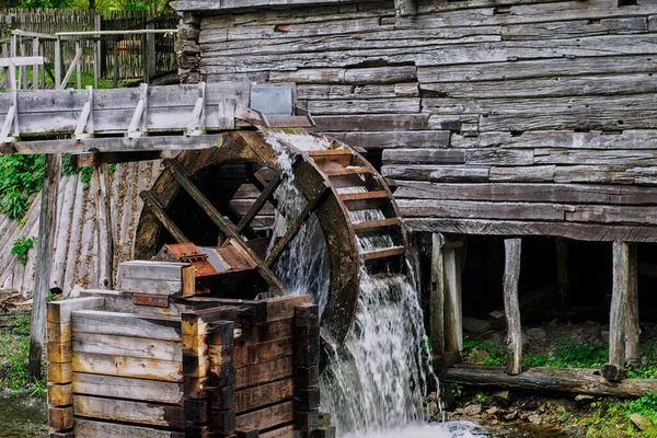 Old water mill, Mill wheel on the river, Sustainable energy and water supply traditional machines