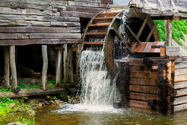 Old water mill, Mill wheel on the river, Sustainable energy and water supply traditional machines