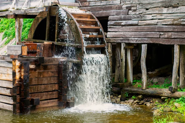 Old water mill, Mill wheel on the river, Sustainable energy and water supply traditional machines