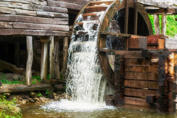 Old water mill, Mill wheel on the river, Sustainable energy and water supply traditional machines