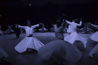 Dervishes perform on the stage for Mevlana clipart