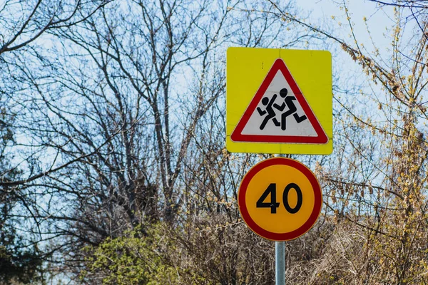 Road sign Caution children and speed limit 40.