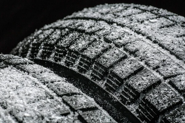 Winter Car tires with snow close-up wheel profile structure on black background — Stock Photo, Image