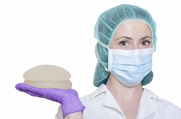 Silicone breast implants. Nurse holding implants. Doctor holding implants. Plastic surgery — Stock Photo, Image