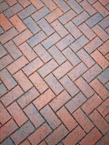Patterned floor made from arranged red bricks ideal for a background