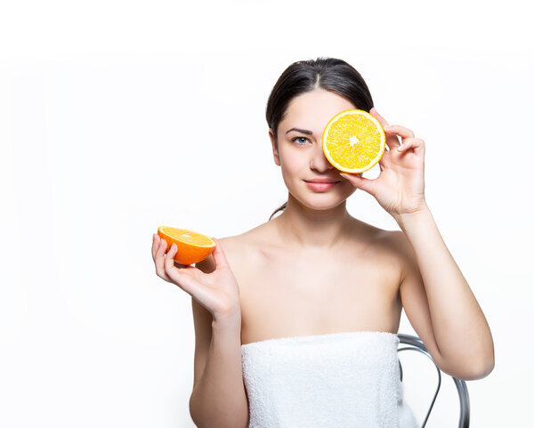 beautiful smiling girl holding an orange