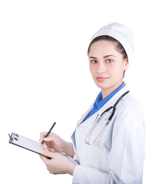 Jovem médico mulher escreve uma receita — Fotografia de Stock