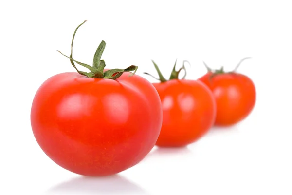 Three ripe isolated tomatoes — Stockfoto