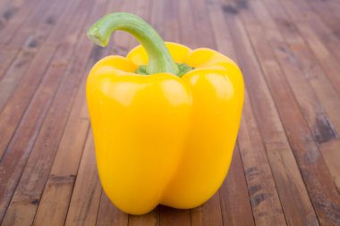 yellow bell pepper on a wooden table