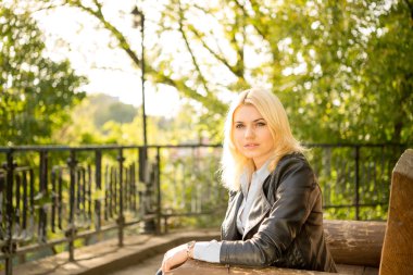beautiful girl on a bench in the sun