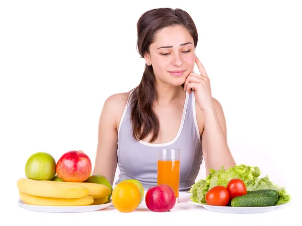 Menina olhando para frutas e legumes na mesa — Fotografia de Stock