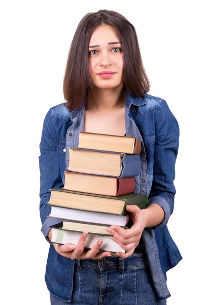 Girl holding a large stack of books — Stockfoto