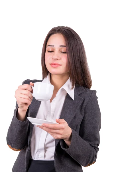 Young business woman smells the aroma of the drink from a cup Stock Picture