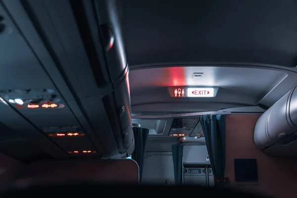 Interior of the passenger airplane. Exit sign. — Stock Photo, Image