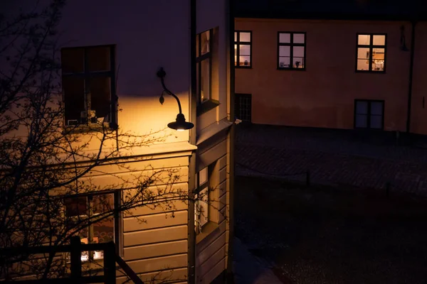 Warm street lighting. cozy narrow European street. Stockholm, Sweden. Cobbled street in Sodermalm