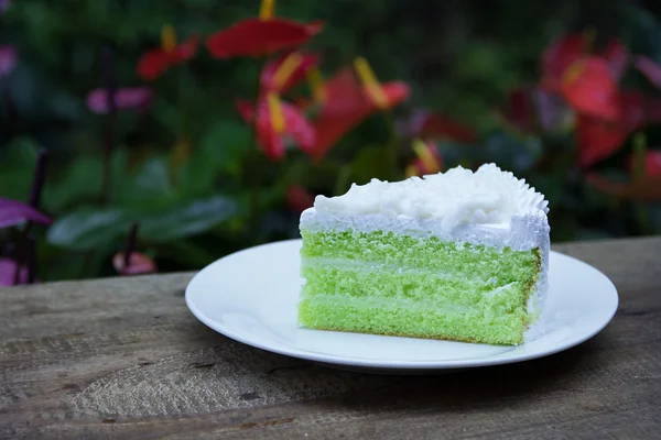 Coconut cake  and flowers background — Stock Photo, Image