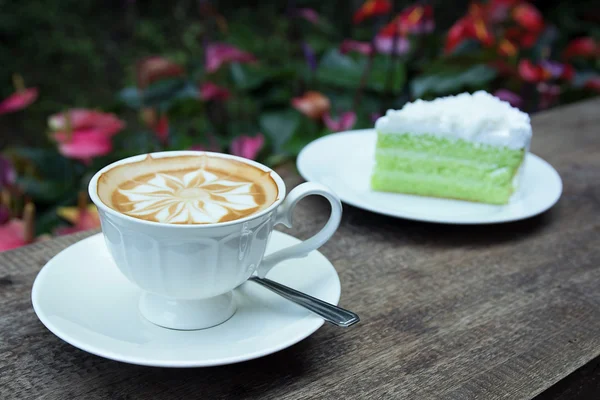 Coconut cake  and flowers background — Stock Photo, Image