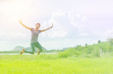 Genç kız atlama çayırda 