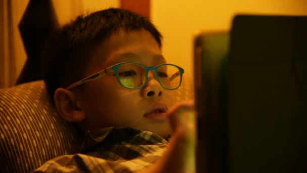 Mladý chlapec hraje hry na posteli — Stock video