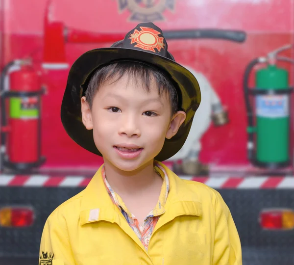 Little boy in firefighter uniform