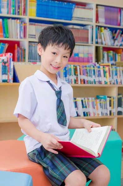 Ученик читает книгу в школьной библиотеке — стоковое фото