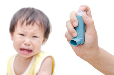 Woman's hand holding asthma inhaler clipart