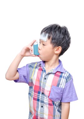 Sick Asian boy using inhaler for asthma clipart