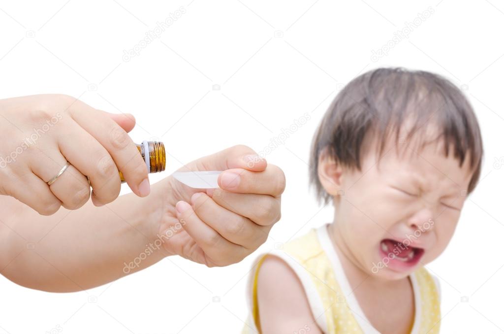 Woman's hands pouring medicine in a spoon