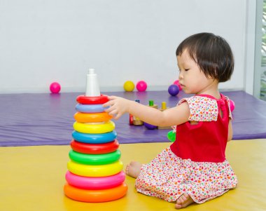 yerde oyuncak oynayan kız