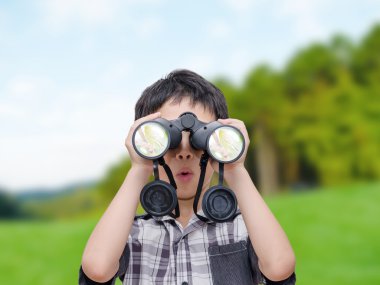 Boy using binoculars in forest clipart