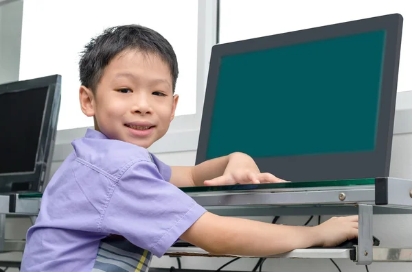 Schoolboy using computer