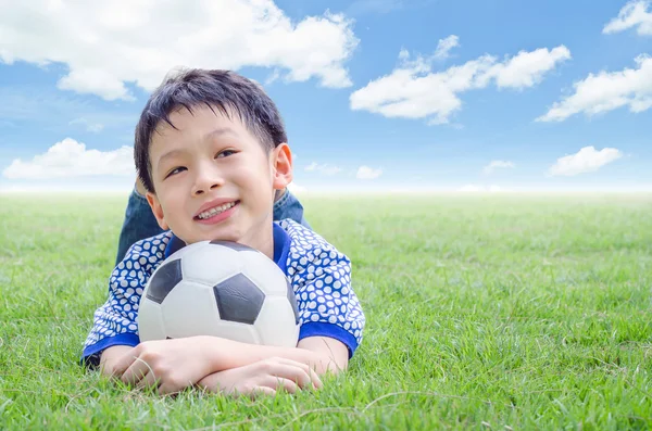 Little boy  with his football on field — Stock Photo, Image