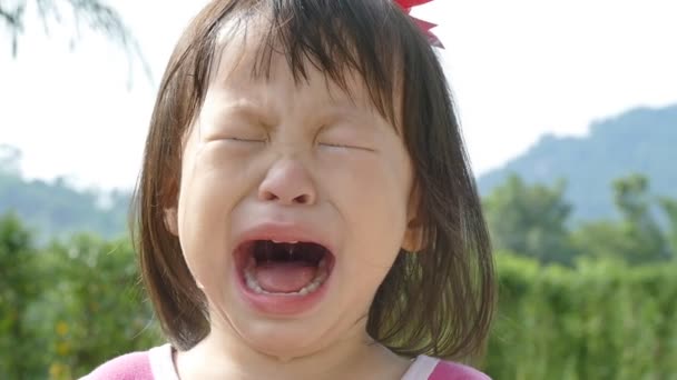 Crying child on natural background — Stock Video